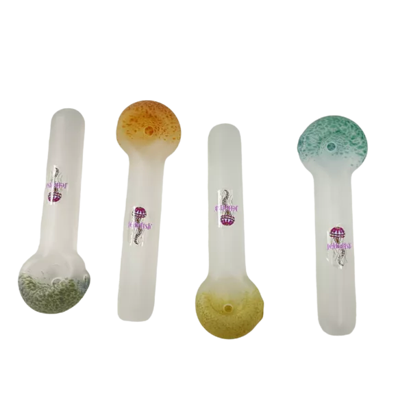 set of three glass pipes with colorful designs on clear bases, sitting on a green surface.