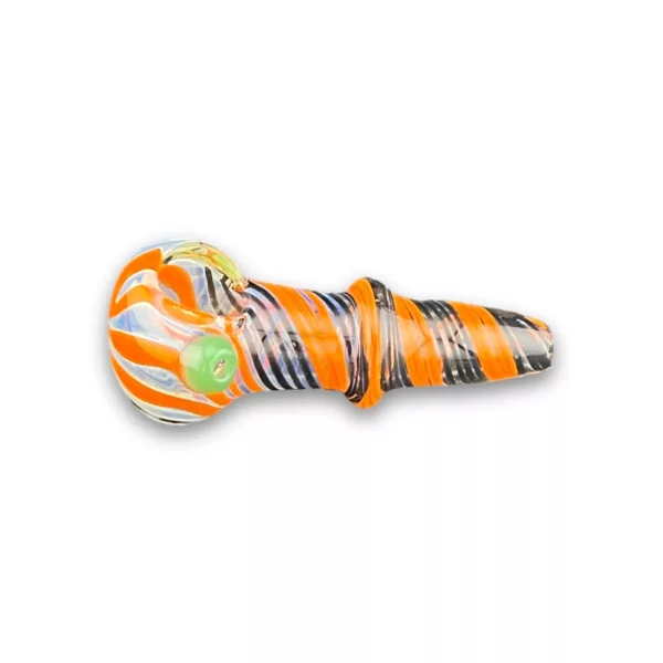 A glass pipe with an orange and white striped design, small hole at the end, sitting on a white surface.