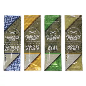 Three hemp cigarette packages with leaf designs in green/brown, blue/brown, and brown/yellow from Twisted Hemp.