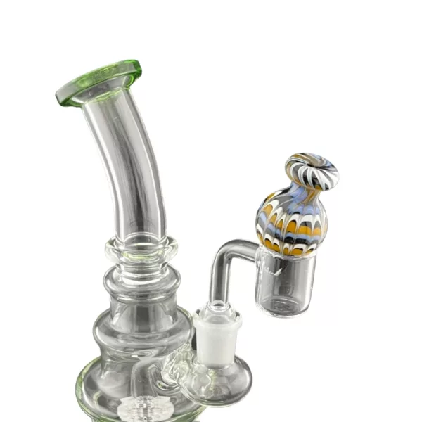 Glass bong with blue and green design, round base, curved neck, and mouthpiece with circular ring. NN1205 Bubble Carb Cap by Smoking Company.