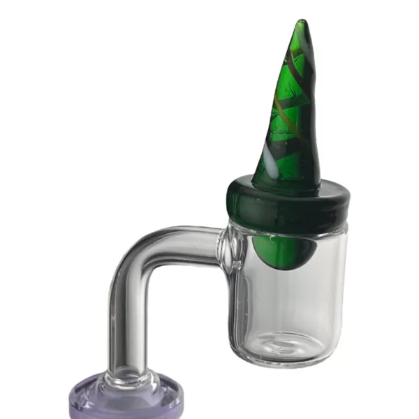 Introducing the Finger Poker Carb Cap - NN1373, a glass pipe with a green and purple cone on top and a small hole at the bottom. It sits on a white surface with a purple base. Perfect for a unique smoking experience.