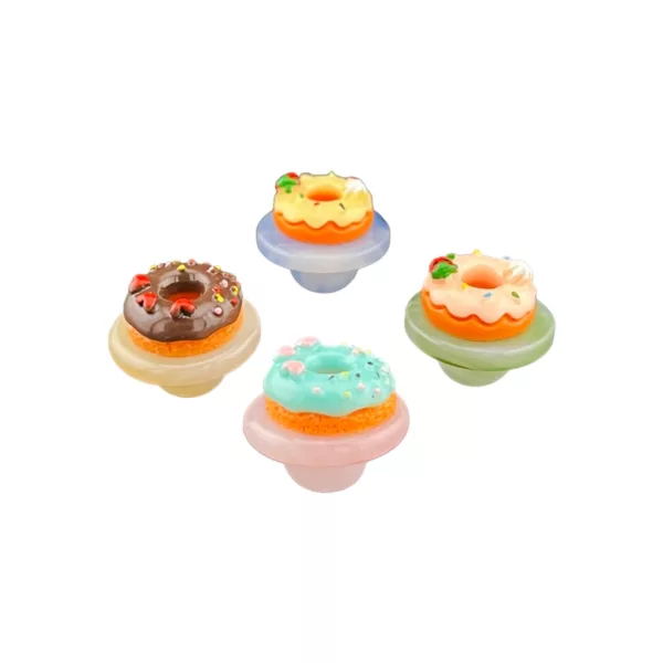 Pastel-colored donuts with sprinkles and a hole in the center, served on a light blue plate with Donut Carb Cap written on the bottom. Well-lit image.