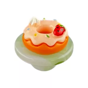 Green iced donut carb cap with strawberry and cherry toppings.