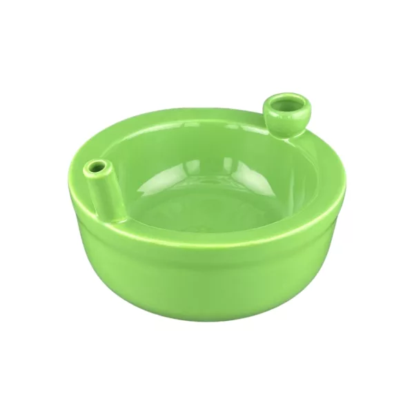 Handcrafted green ceramic bowl with small openings and curved handle. Smooth surface and vibrant lime green color.