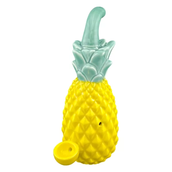 Ceramic pineapple ashtray designed for holding cigars, with a pointed bottom and small hole for insertion. Sides are raised and base has a small indentation for ashes.