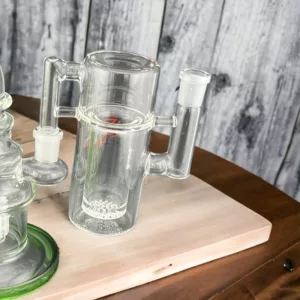 Cylindrical glass ashcatcher with small mouthpiece and large opening, sits on wooden table with adjustable metal rod.