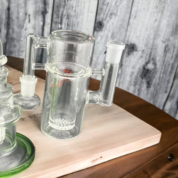 Cylindrical glass ashcatcher with small mouthpiece and large opening, sits on wooden table with adjustable metal rod.