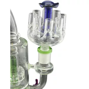 Jellyfish-shaped smoking device with small bowl, six smoke holes, two smoking holes, blue/green stem and base, made of clear glass with blue/green accents.