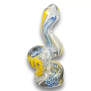 glass sculpture of a swan with a blue and yellow body and a white base. The swan’s head is tilted to the right and its wings are spread out to the left. The swan’s body is curved and its tail is long and curved. The base of the sculpture is white and the swan’s body is transparent.