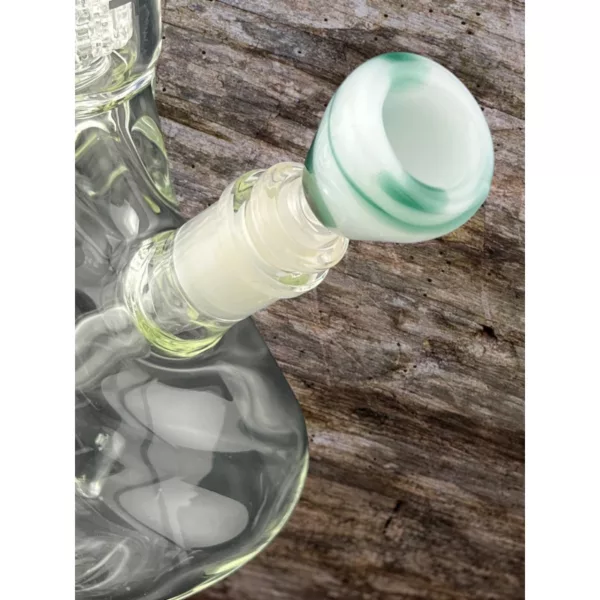 Frosted green & white striped glass bowl pipe with 'Frosted Trapezoid Bowl' written on side. Used with dents and scratches on glass, weathered wooden surface.
