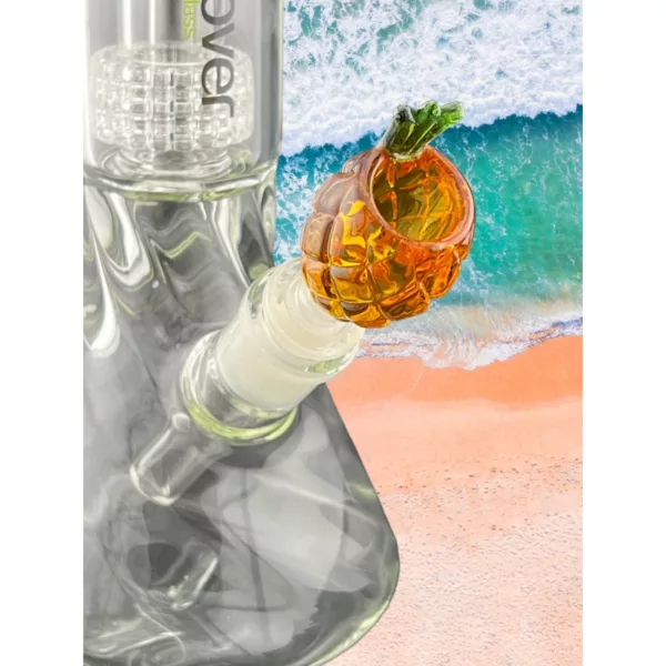Glass pipe with pineapple bowl on top, set against a sandy beach backdrop.