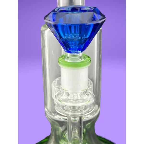 clear top and green bottom with blue gem. Short stem, round base, and small ring for stability.