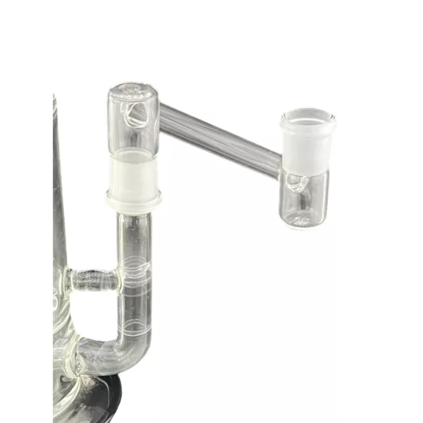 A clear glass water pipe with a small hole and stem, connected to a larger jar with a handle, for smoking.