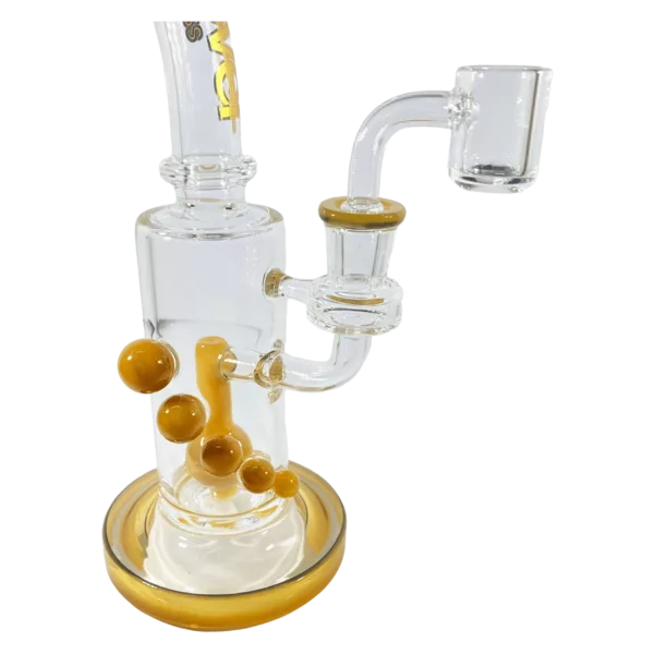 Large glass bong with yellow marbles and gold stand. Clear glass base with stem hole.