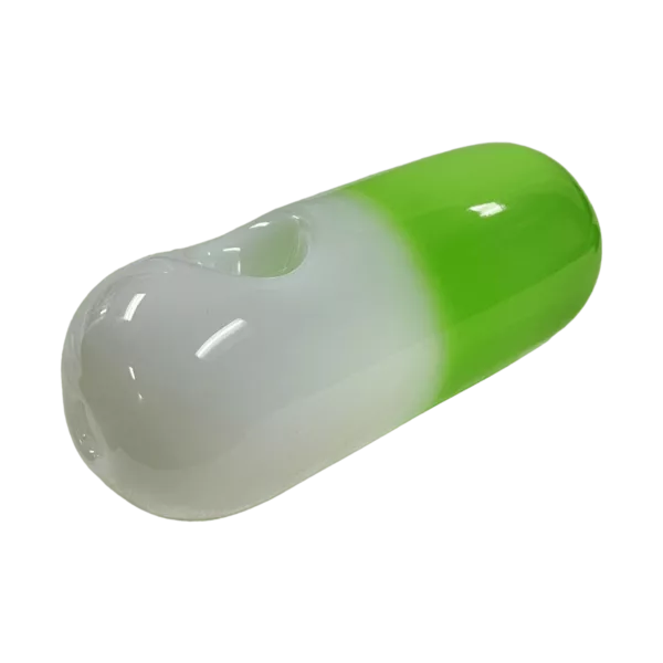 Green and white striped pill on green surface with white background.
