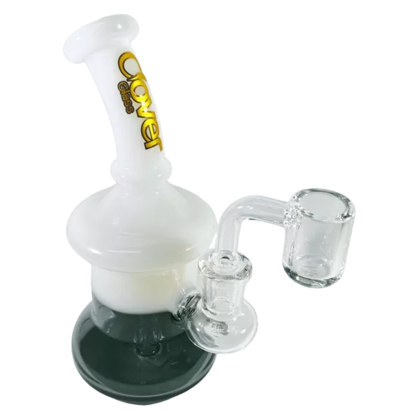 A clear glass bong with a white acrylic stem and percolator, featuring a large white bowl and small white rings around the base and stem.