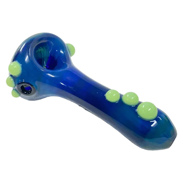 Blue glass pipe with green and yellow dots. Curved shape. Clear glass. Small bowl and stem with clear glass knob and hole surrounded by dots. White background.