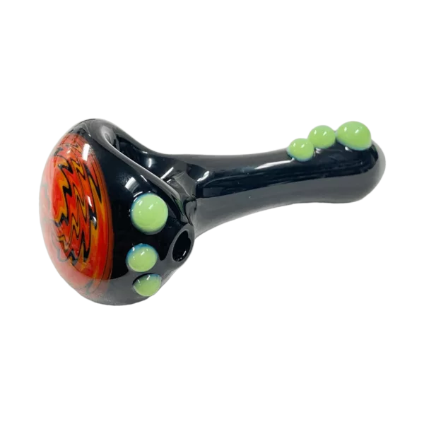Black and green glass pipe with spiral pattern of round beads on bowl and mouthpiece.