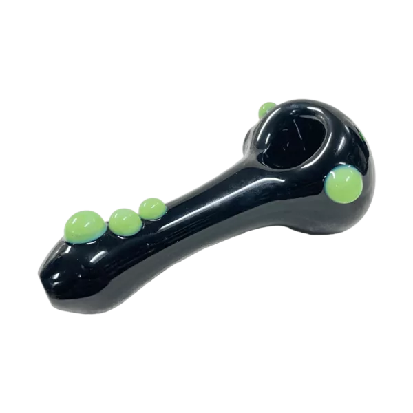 A clear glass Black Wigwag Spoon from Multiverse Glass features bright green dots around its circumference and a small hole for smoke.