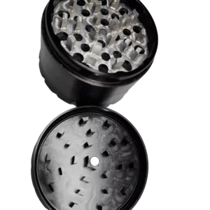 Close-up of empty black grinder with glass container and small spikes on top and bottom, surrounded by black beads.