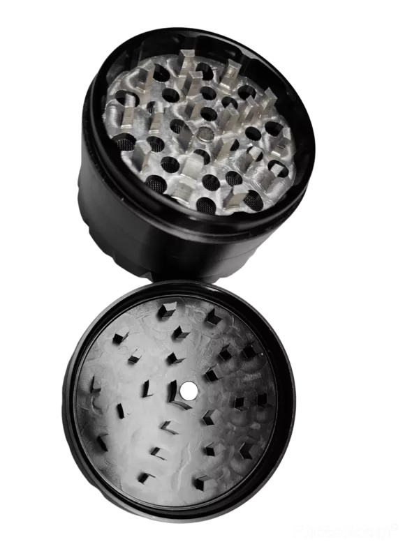 Close-up of empty black grinder with glass container and small spikes on top and bottom, surrounded by black beads.