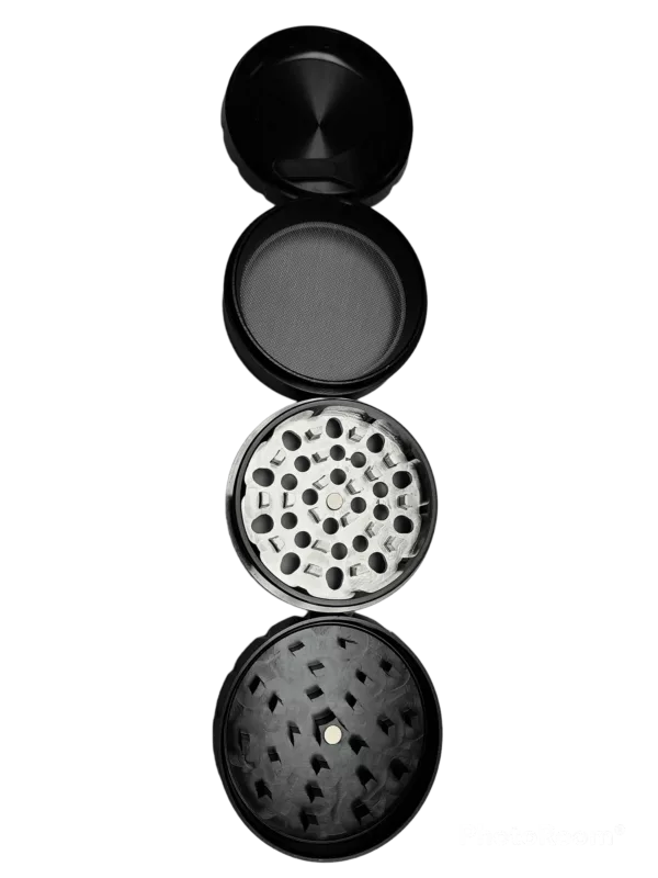 A sleek, modern black metal grinder with a circular base and handle for grinding herbs and spices into a fine powder.