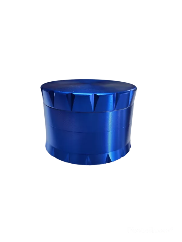 Blue metal grinder with rectangular shape, round base, and small handle on lid. Sitting on green background.