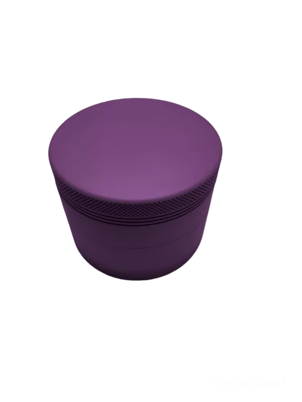 Slick Mate Grinder with white base, purple lid, 2 holes, small handle, and 2 white feet for stability.