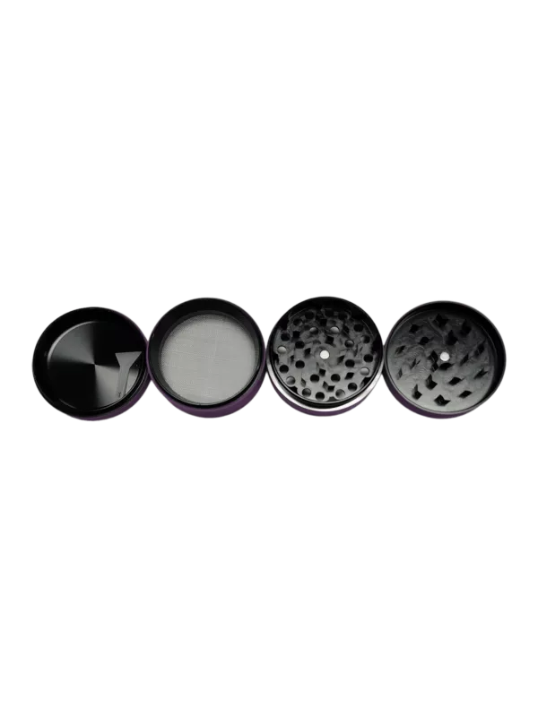 Slick Mate Grinder features three circular pieces of glass with a black and silver pattern on the top, a transparent middle piece, and a metallic silver bottom with a circular hole in the middle.