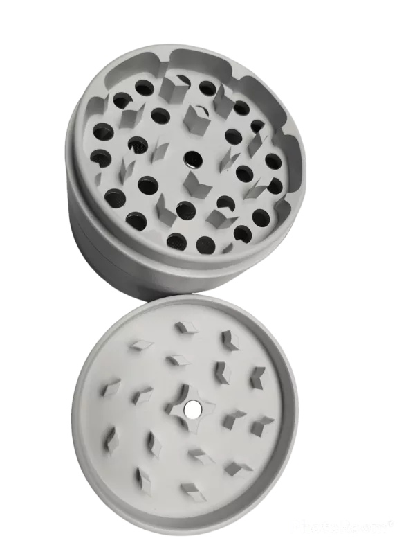 White plastic grinder with 6 small holes for easy use. Cylindrical shape with flat base and raised spindle. Perfect for grinding herbs and spices.