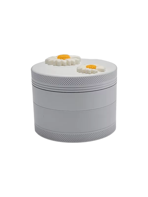 White plastic grinder with yellow sunflower design, circular shape and small knob on top for easy use.