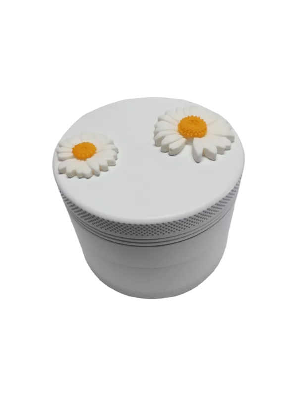 White plastic grinder with two yellow daisies on top, round shape and small opening.