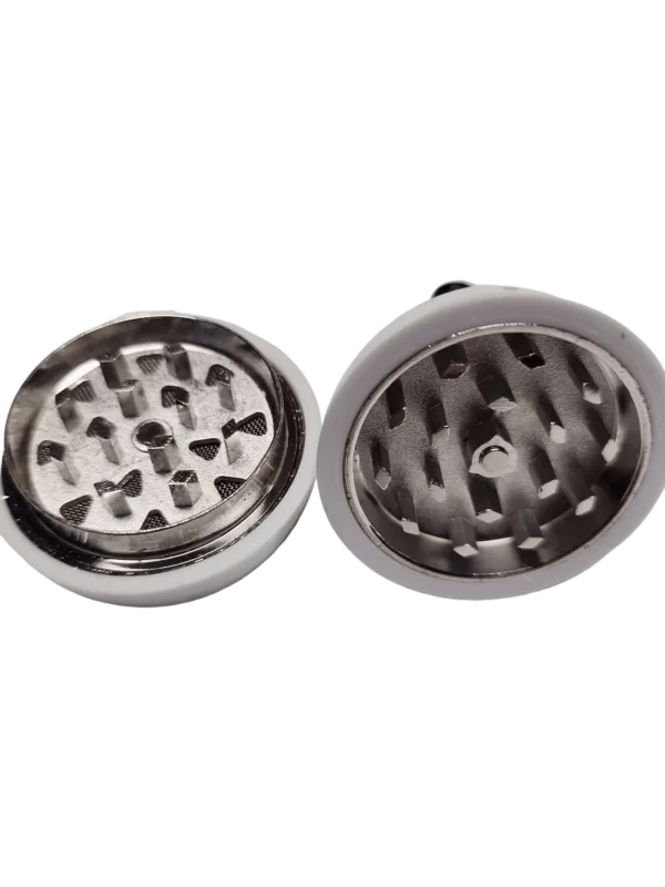 small herb and spice grinder with a metal cylinder and teeth that spin to create a fine powder. It has a cylindrical container with a hole on top and a knob to adjust the amount of herbs or spices.
