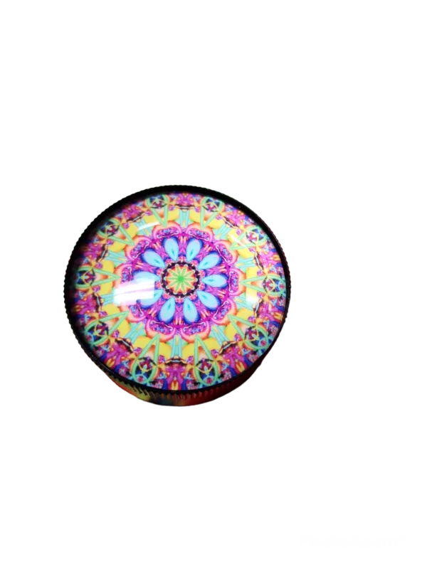 A round, colorful, shiny grinder with intricate patterns on it - BVGS110.