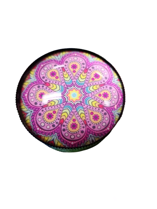 Psychedelic glass grinder with light blue background and pink, yellow, and purple patterns.