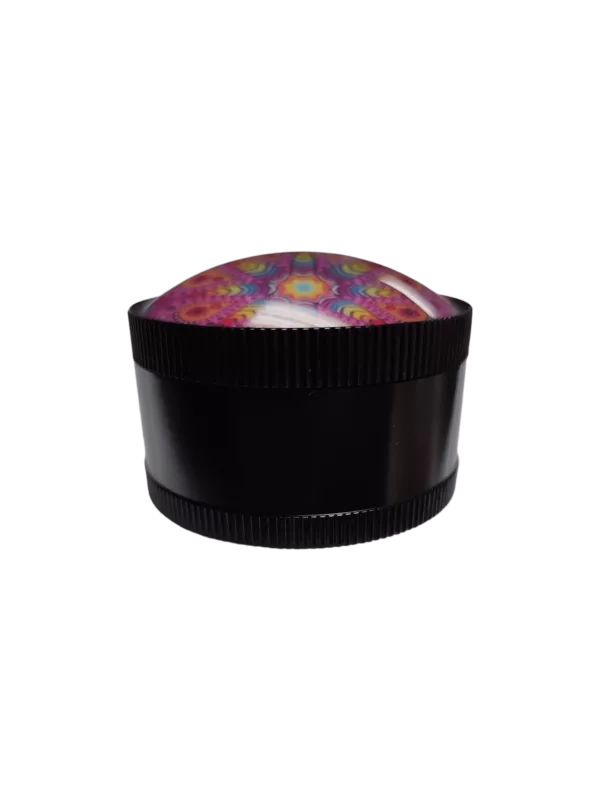 The White Girl Grinder BVGS110 has a round, black container with a colorful, psychedelic design. It has a flat bottom and raised rim. The image is lit from the top, making the colors appear vibrant and saturated.