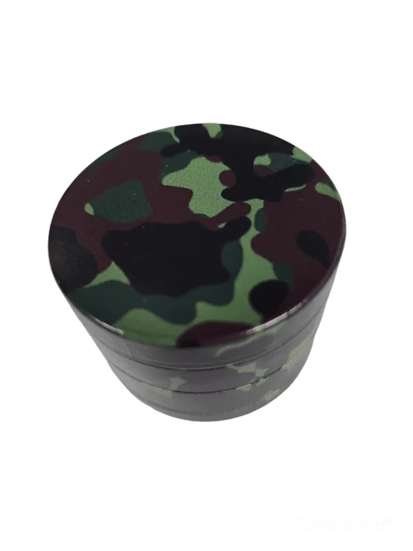 A camouflage patterned plastic grinder with a green background and round shape.