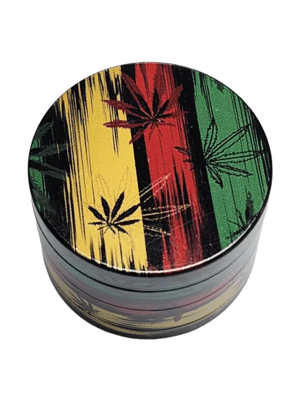A colorful, round metal grinder with a leafy design and red, yellow, and green stripes on a green background.