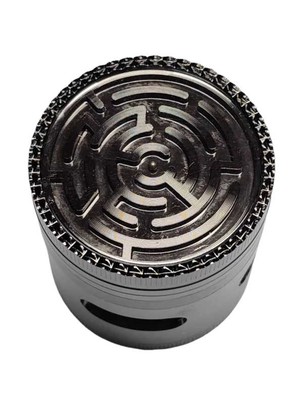 Shiny silver grinder with circular design and maze pattern for visually appealing herb grinding. Small opening in center.