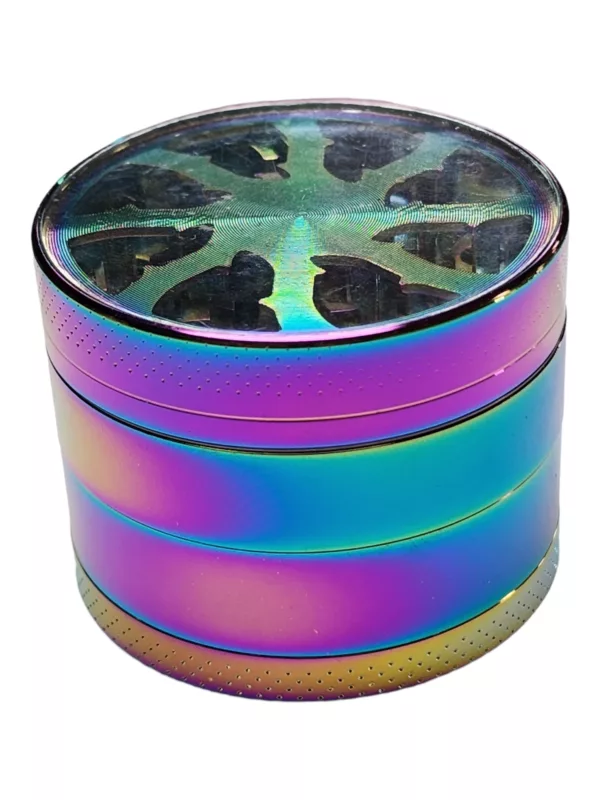A colorful, metallic grinder with a rainbow iridescent surface and a small hole in the center, sitting on a white surface.