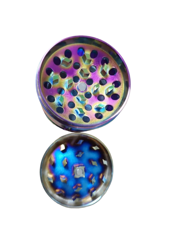 Rainbow herb grinder with concave side and circular holes for efficient grinding. Silver base and hinge for easy use.