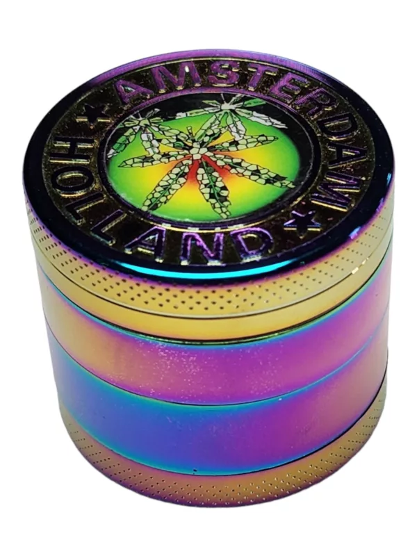 Small, round metal grinder with a colorful marijuana leaf and star design. Shiny, reflective surface. Made of brass or copper.