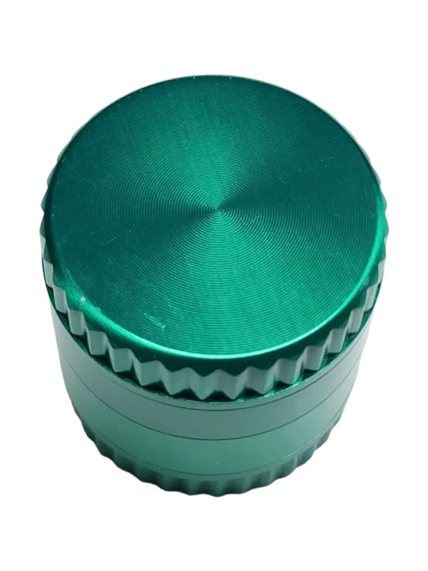 Green metal grinder with 4 tiers, smooth surface, open lid, reveals contents. Sitting on green background.