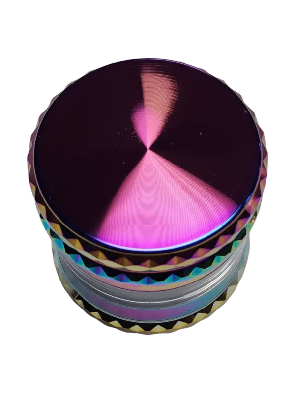 Compact rainbow-colored glass grinder for grinding dry herbs. Features a clear base with a hole for filling and a stainless steel top with a small hole for inserting herbs. Perfect for indoor and outdoor use.