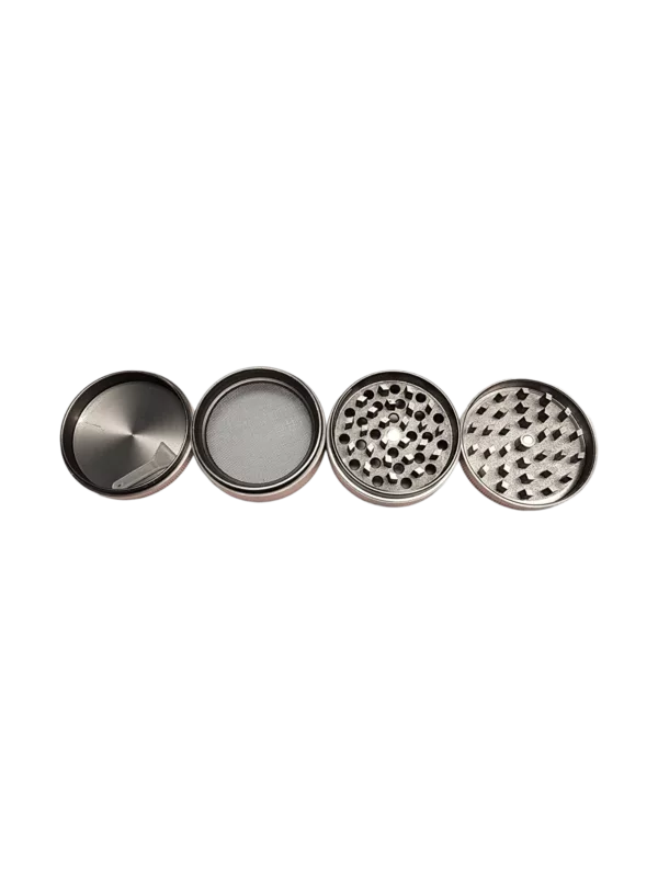 Four metal grinder cups with grooved blades and a mesh screen for smoking tobacco. Green background.