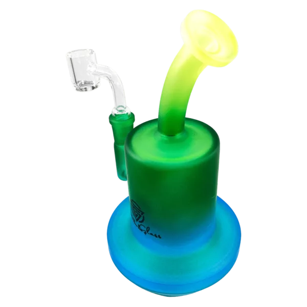A glass bong with a blue and green tinted base, clear stem, and small stand with a green base. The bong has a small hole at the bottom for water to flow through and the stand has a small hole at the top for water to flow through.