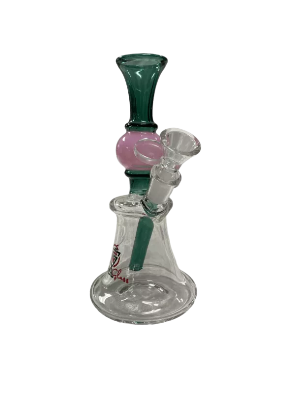 Eye-catching pink and green glass bong with clear base and small hole at the top, sitting on a green table.