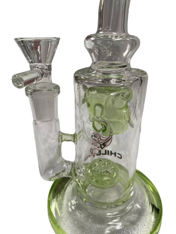 Green Ice Cube Rig - JLE205: Glass bong with green stem, clear base, and two bowls connected by a clear tube. Sat on a clear stand with a small hole and knob.