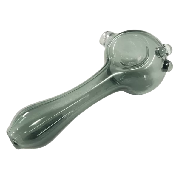 Clear, smooth glass spoon with cylindrical shape and round base on green background.
