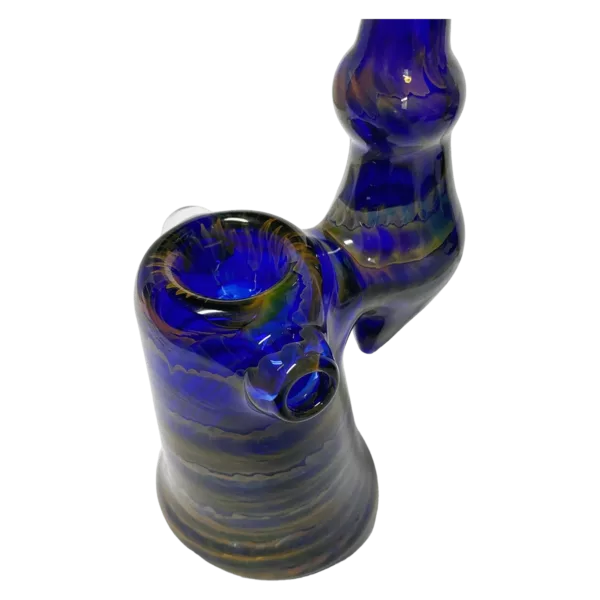 Dragon-shaped bong with blue/purple swirls, smoke and water inlets. Sits on green table.